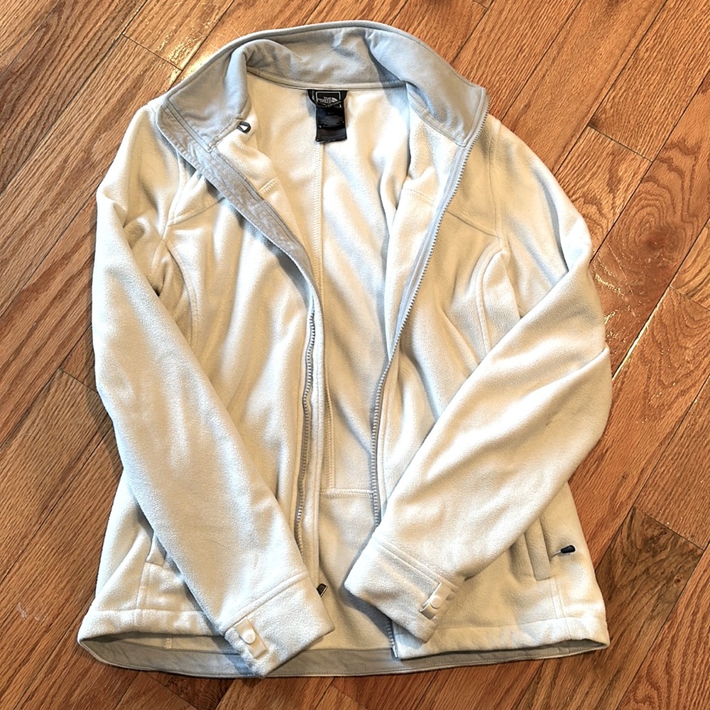 White Northface zip up jacket with grey lining. No hood. Size M.